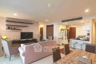 Spacious living room with modern decor and open kitchen layout