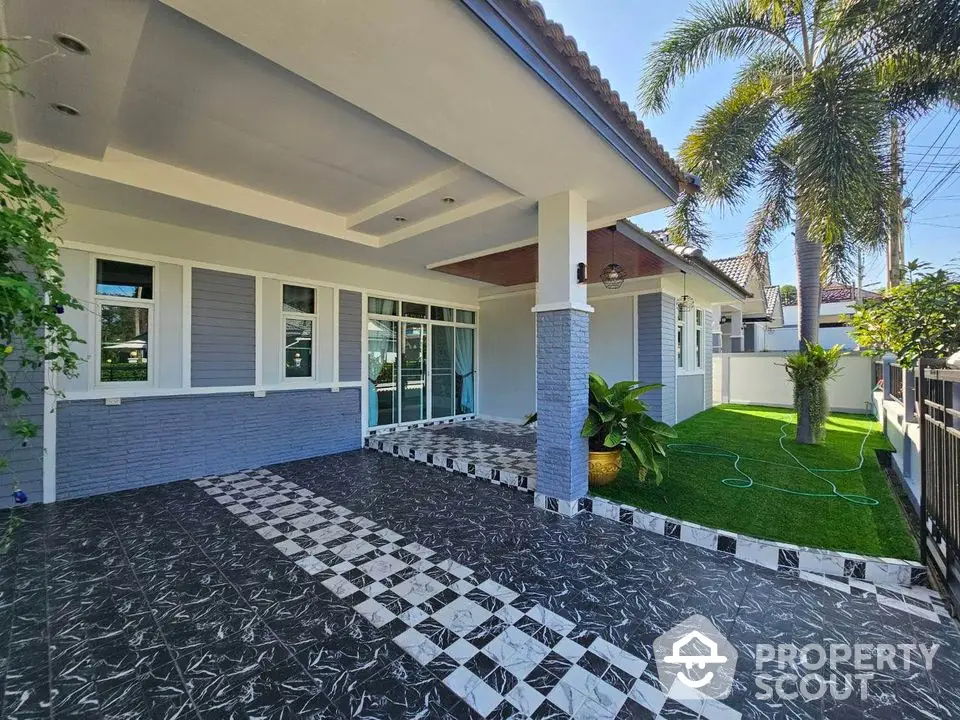 Charming modern home with spacious patio and lush garden, perfect for outdoor living.