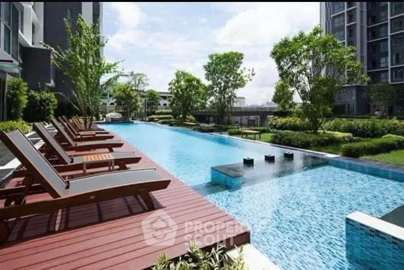 Luxurious apartment complex with stunning outdoor pool and lush greenery.