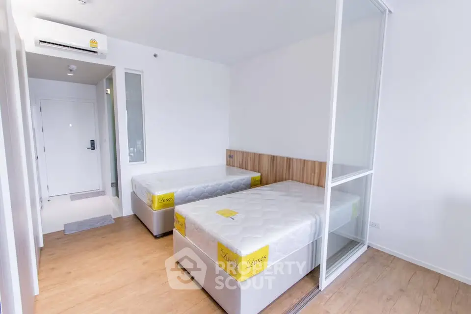 Modern twin bedroom with minimalist design and natural light