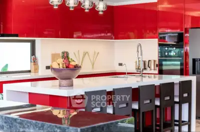 Modern kitchen with red cabinets and sleek island