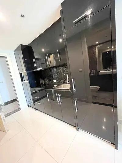 Modern kitchen with sleek black cabinets and glossy finish