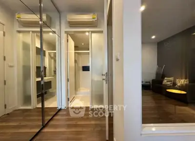 Modern apartment interior with mirrored closet and cozy living area