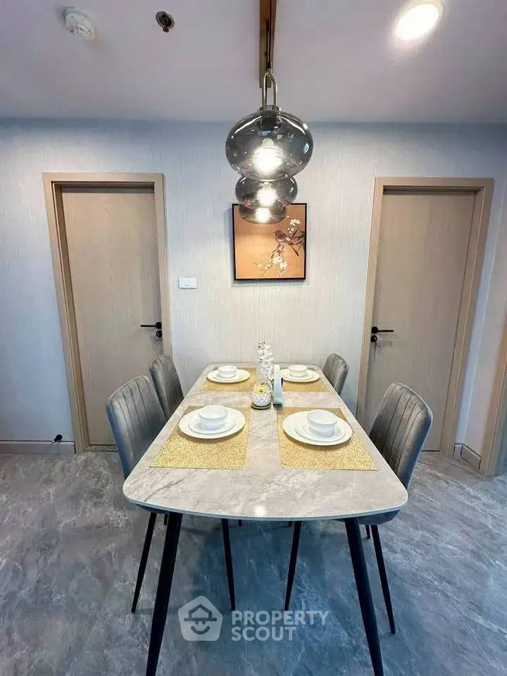 Modern dining area with elegant table setting and stylish lighting in a contemporary apartment.