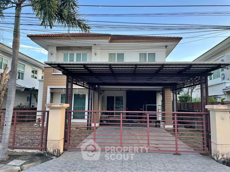 Charming two-story house with gated driveway and modern design in a serene neighborhood.