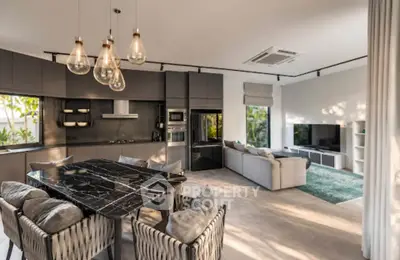 Luxurious open-plan living room with modern kitchen and stylish decor