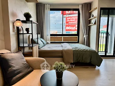 Modern bedroom with large window and balcony access in stylish apartment