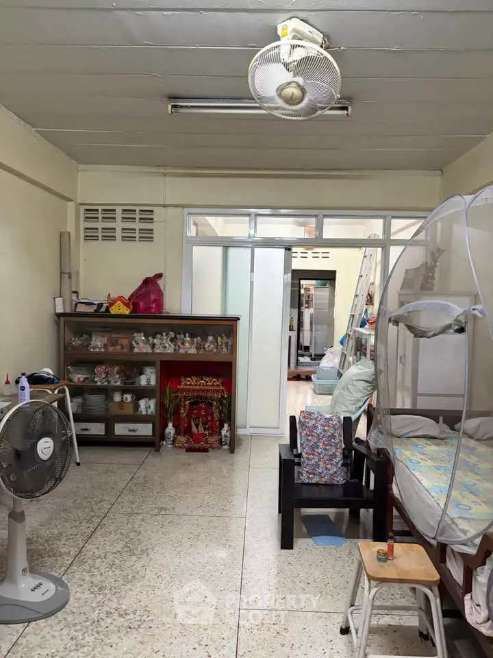 Cozy living space with eclectic decor and ceiling fan