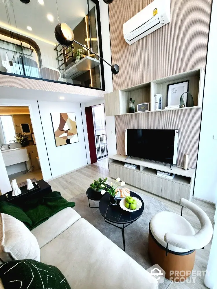 Modern living room with high ceiling, stylish decor, and mezzanine level in luxury apartment