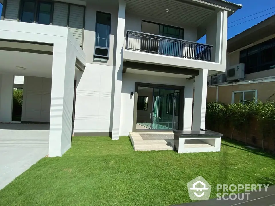 Modern two-story house with spacious lawn and balcony