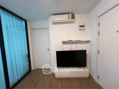 Modern living room with sleek TV setup and air conditioning unit