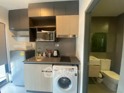 Modern compact kitchen with washing machine and bathroom view