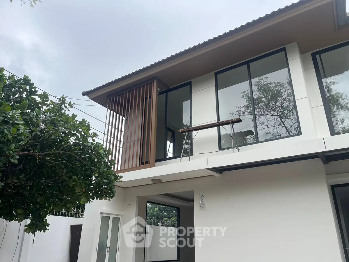 Modern two-story house with large windows and sleek design