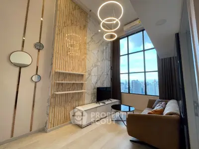 Modern living room with high ceilings, large window, and stylish lighting fixtures.
