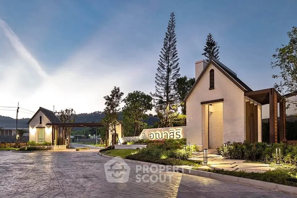 Stunning modern residential entrance with lush landscaping and elegant architecture.
