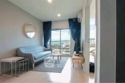 Modern living room with stylish furniture and balcony view in a high-rise apartment.