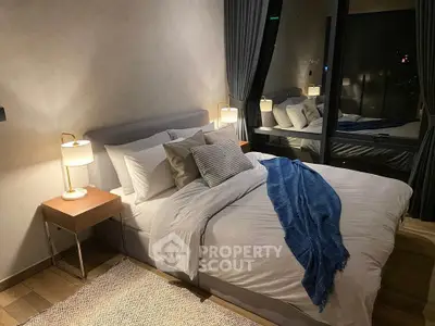 Luxurious bedroom with modern decor and large window offering stunning night views.