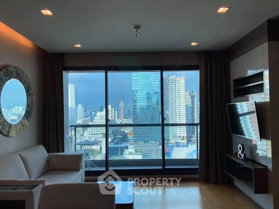 Luxurious living room with stunning city view and modern decor in high-rise apartment.