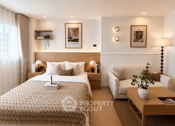 Elegant bedroom with cozy decor, featuring a stylish bed, modern lighting, and a comfortable seating area.