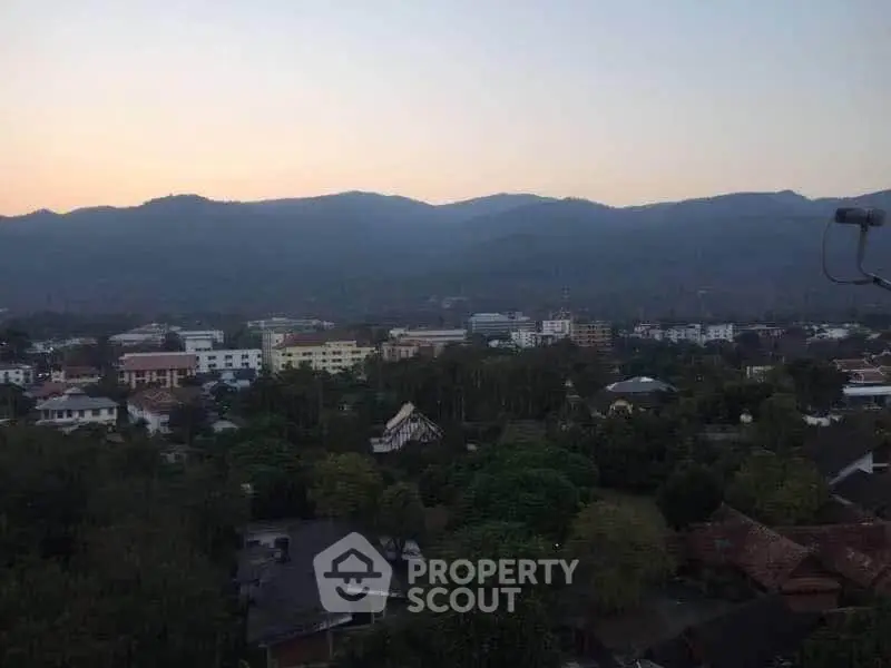 Scenic mountain view over a tranquil residential area at dusk, perfect for serene living.