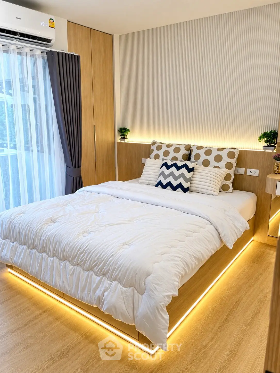 Modern bedroom with stylish lighting and cozy decor in a contemporary apartment.