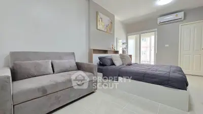 Modern bedroom with cozy sofa and stylish decor in a bright apartment