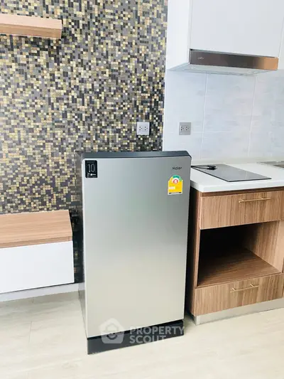 Modern kitchen with sleek fridge and stylish backsplash
