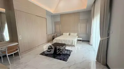 Spacious modern bedroom with elegant decor and natural light