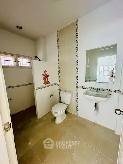 Spacious modern bathroom with elegant tile design and natural light