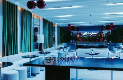 Luxurious modern lounge with ambient lighting and stylish decor, perfect for entertaining guests.