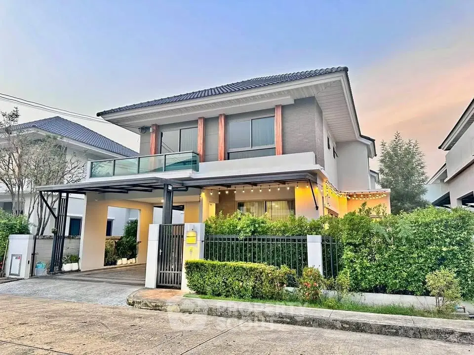 Charming two-story house with modern design, lush garden, and spacious driveway in a serene neighborhood.