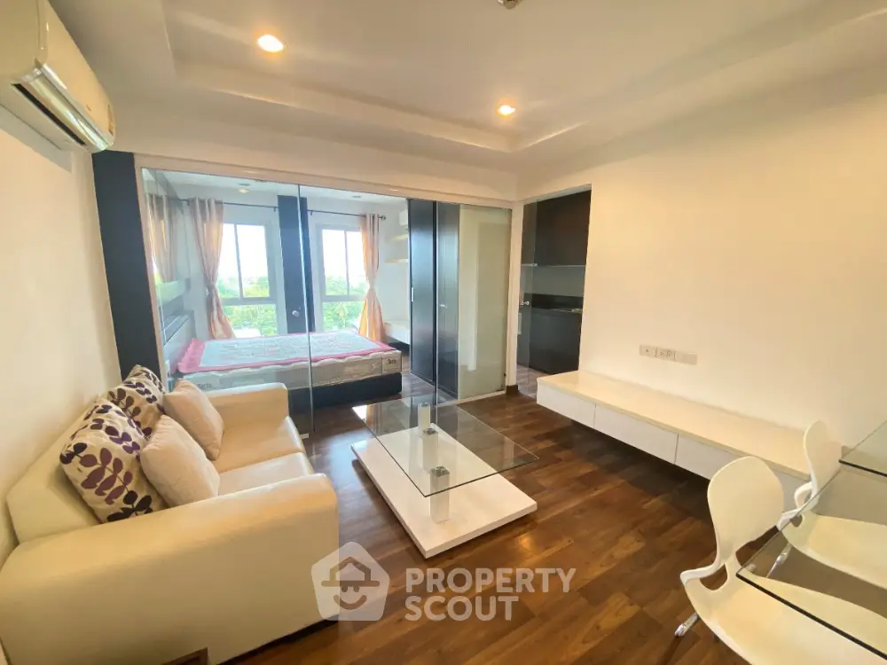 Modern living room with glass wall bedroom and stylish furniture