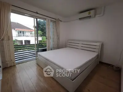 Spacious bedroom with balcony access and natural light