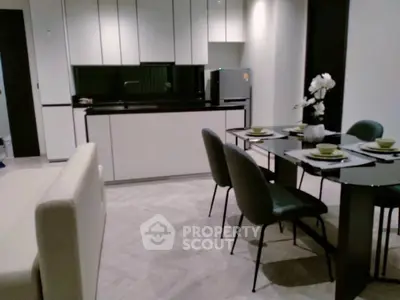 Modern open-layout kitchen and dining area with sleek furniture and elegant decor