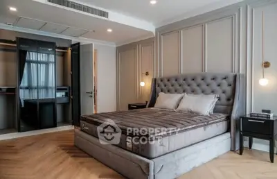 Luxurious bedroom with elegant decor and plush bedding in modern apartment.
