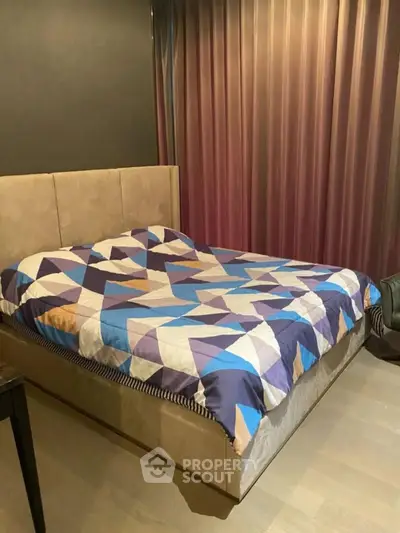 Modern bedroom with stylish geometric bedding and elegant curtains
