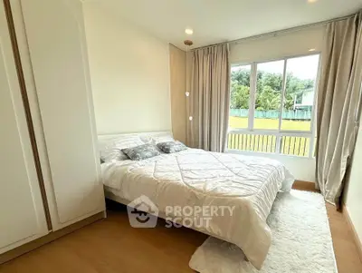 Bright and cozy bedroom with large window and elegant decor