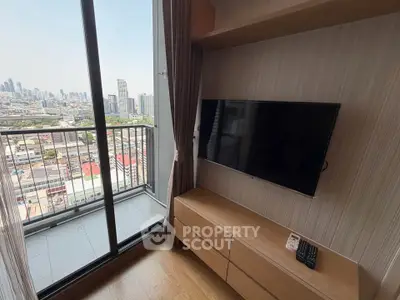 Modern living room with balcony and city view, featuring a wall-mounted TV and sleek wooden furniture.