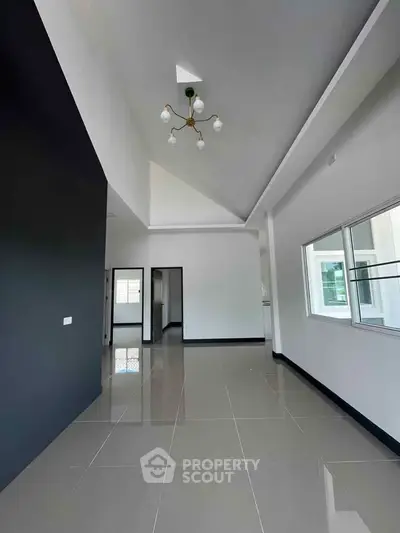 Spacious modern living room with high ceilings and sleek tile flooring
