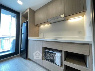 Modern kitchen with sleek cabinetry and built-in appliances in a stylish apartment.