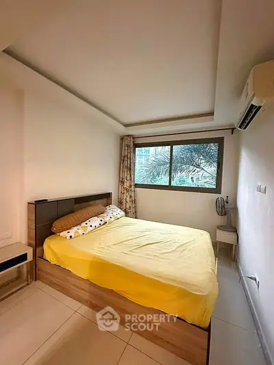 Cozy bedroom with large window and air conditioning, featuring a comfortable bed and modern decor.