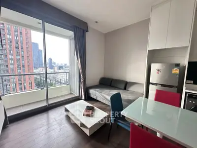 Modern living room with city view and balcony access in high-rise apartment