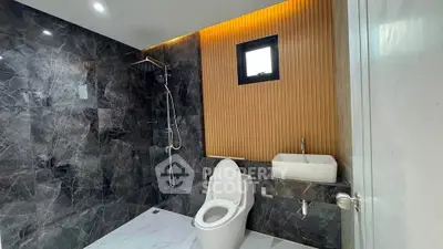 Luxurious modern bathroom with marble walls and sleek fixtures