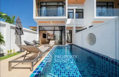 Luxurious modern villa with private pool and sun loungers, perfect for relaxation and entertainment.