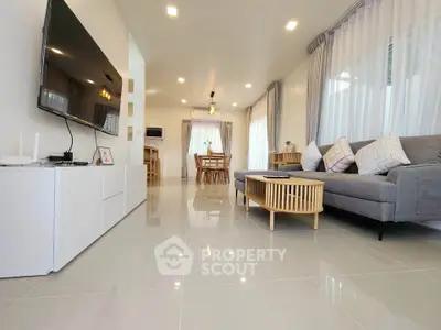 Spacious modern living room with sleek design and abundant natural light.