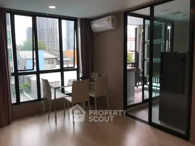 Modern apartment dining area with large windows and city view