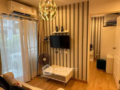 Chic living room with modern decor, striped wallpaper, and natural light from balcony.