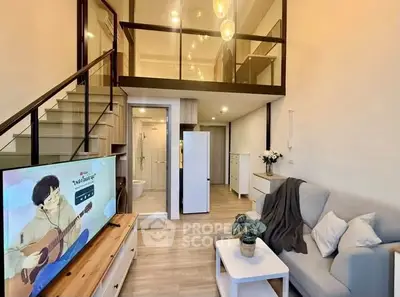 Modern loft apartment with stylish living room and mezzanine, featuring cozy seating and elegant lighting.