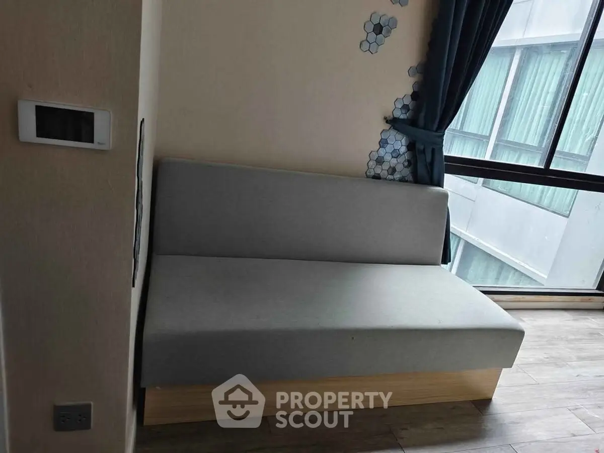 Modern apartment interior with minimalist sofa and large window view