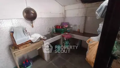 Cozy kitchen with rustic charm and practical layout, featuring ample storage and workspace.